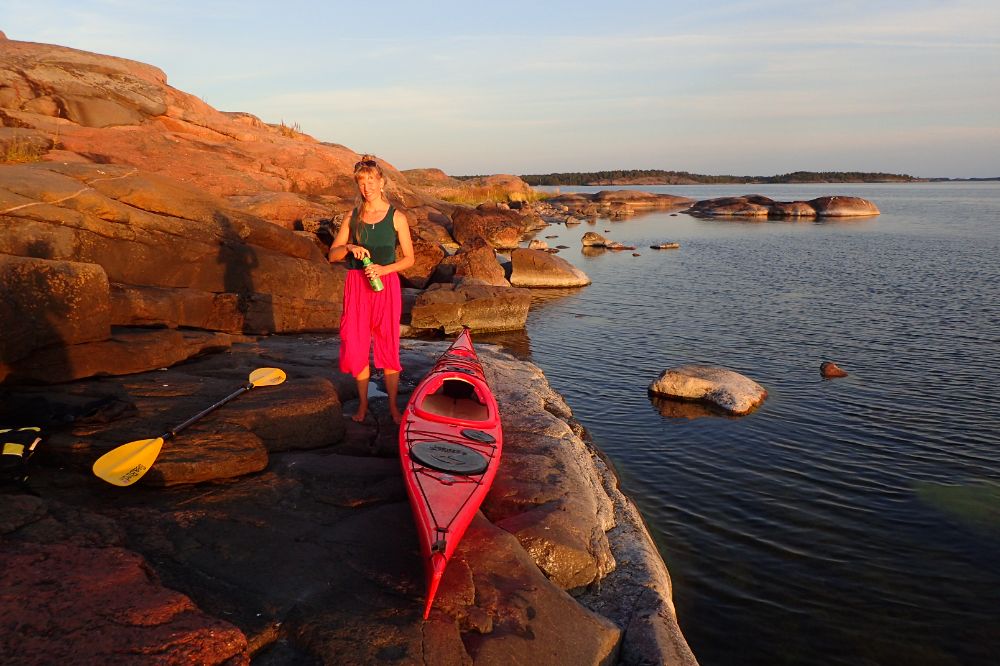 ElinMaria and her kayak on a rock at sunset